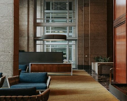 A modern corporate office lobby interior in a high-rise building with soft lighting in downtown South Jakarta
